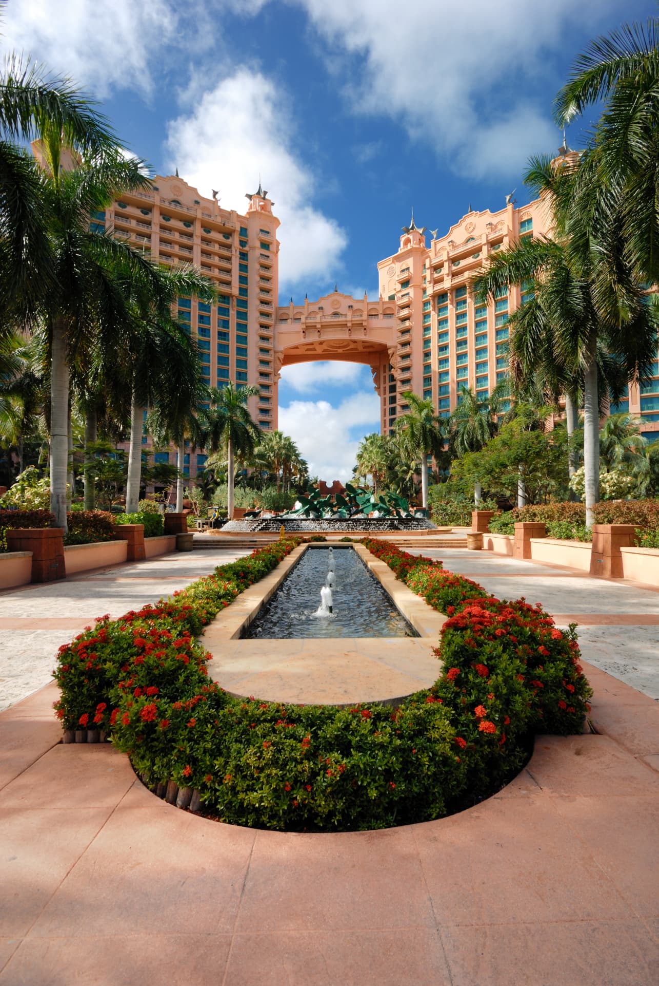 Resort towers and fountain garden framed by palms