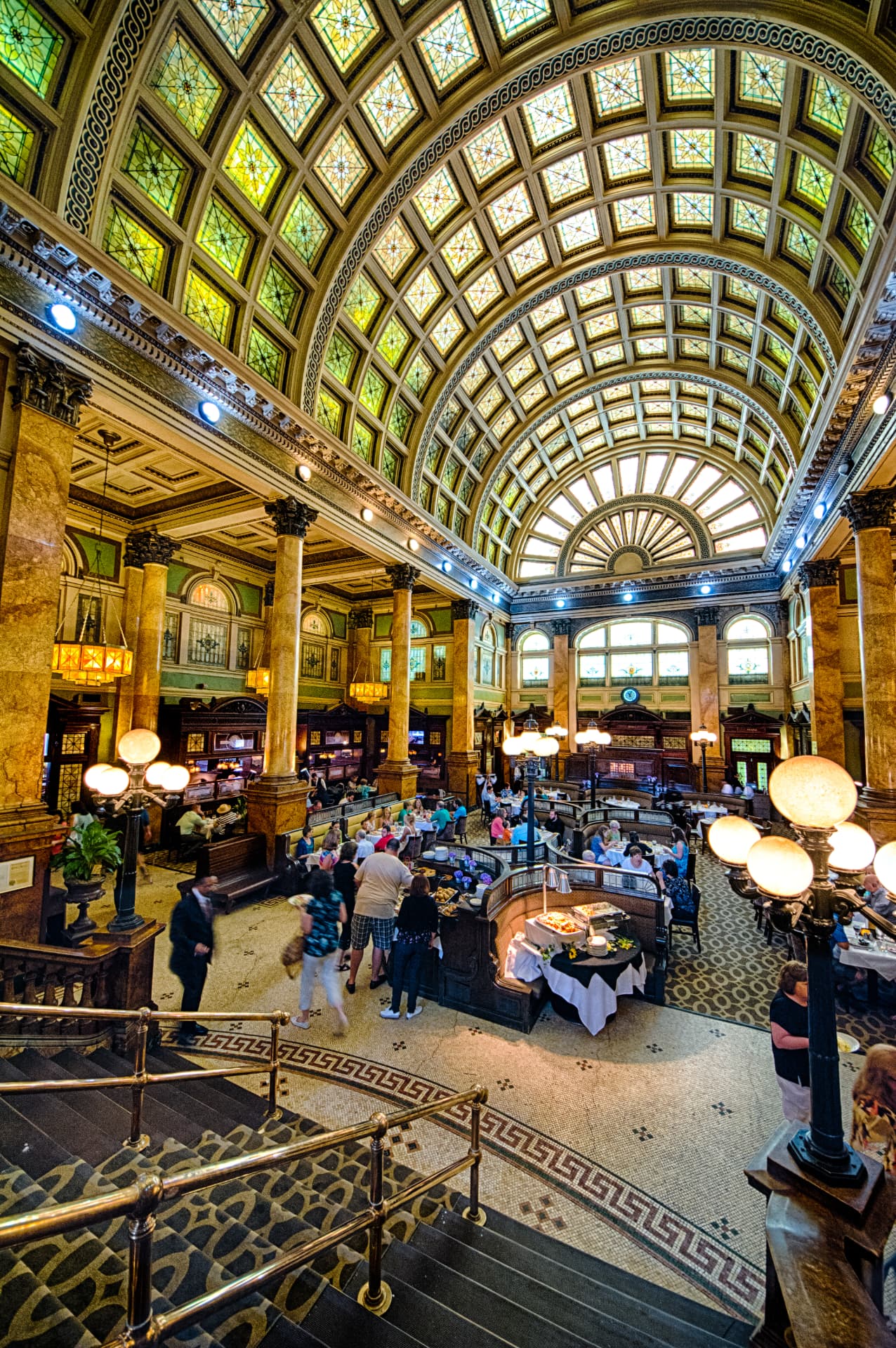Stained glass dome above a grand historic dining hall
