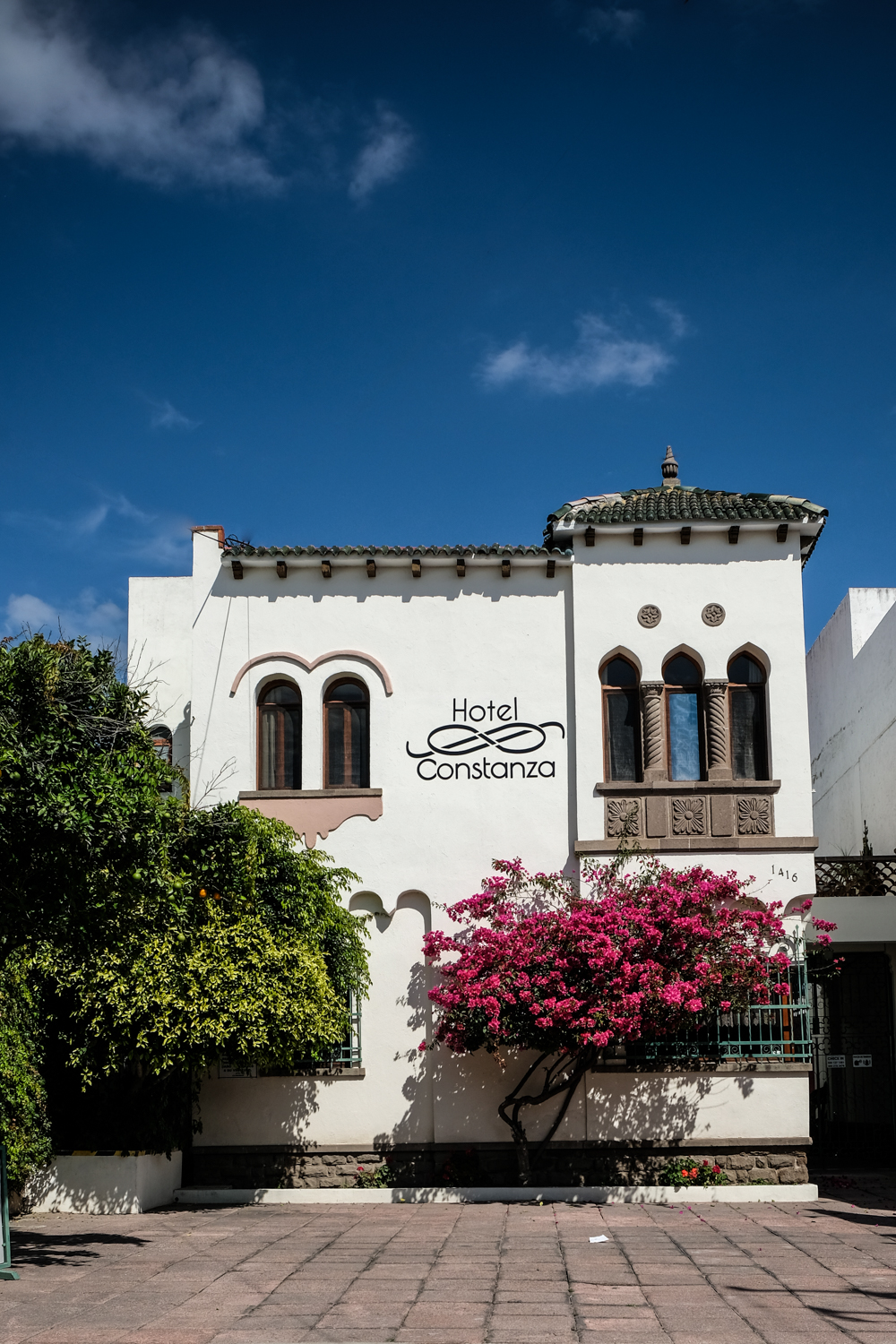 Hotel Constanza facade with bougainvillea in bloom